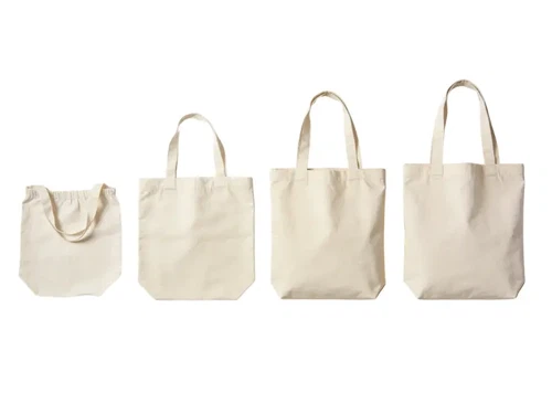 Four tote bags arranged from lightest to heaviest fabric weight showing the visible difference between 4oz cotton, 8oz cotton, 12oz canvas, and 16oz heavy canvas Four tote bags arranged from lightest to heaviest fabric weight showing the visible difference between 4oz cotton, 8oz cotton, 12oz canvas, and 16oz heavy canvas