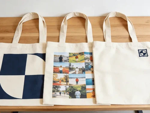 Three canvas tote bags showing different customization methods - screen printing, heat transfer printing, and embroidery - compared side by side Three canvas tote bags showing different customization methods - screen printing, heat transfer printing, and embroidery - compared side by side